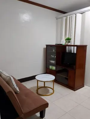 a living room with a couch and a tv at Makati Transient Condo 3BR with Balcony, Wifi in Manila