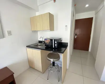 a small kitchen with a sink and a microwave at Dian SUITES 1 in Manila