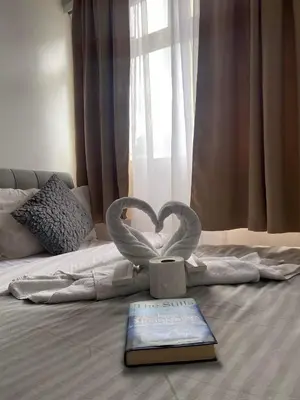 a book and a heart statue on a bed at Buenbyahe Cozy Affordable Place at Urban Deca Tower along EDSA Shaw MRT walking distance in megamall in Manila