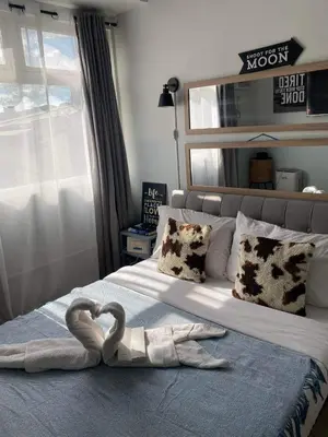 a bedroom with two swans towels on a bed at Buenbyahe Cozy Affordable Place at Urban Deca Tower along EDSA Shaw MRT walking distance in megamall in Manila
