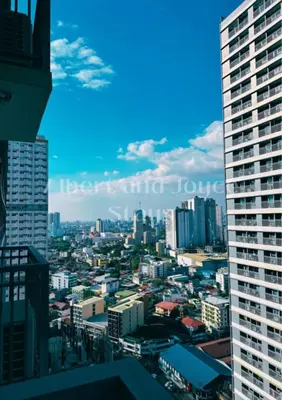 a view of a city with tall buildings at Emma Mattress 1BR CONDO @ FAME (pool & city view) in Manila