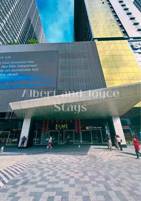 a store in a city with people walking in front of it at Emma Mattress 1BR CONDO @ FAME (pool & city view) in Manila