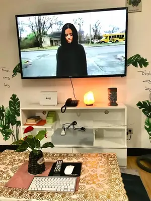 a tv on a wall with a woman on the screen at The Escape Pad 7 in Manila