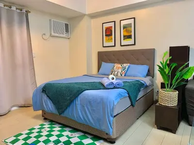 a bedroom with a bed with towels on it at Modern Condo At Venice Residences Bgc #vlrb29k in Manila