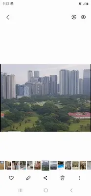 two photographs of a city skyline with tall buildings at Grand Canal Penthouse! in Manila