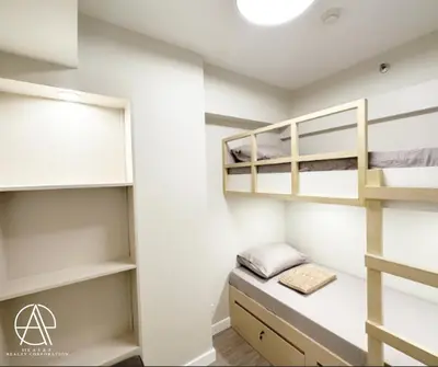 a dorm room with bunk beds and a desk at Casa Escudero in Manila