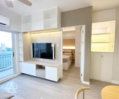 a living room with a television and a bedroom at Casa Escudero in Manila