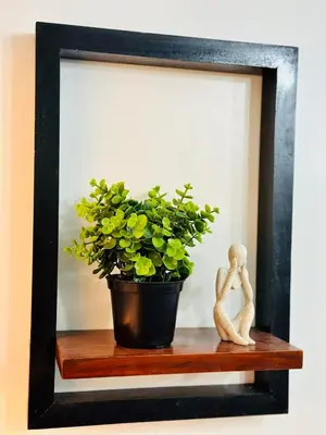 a picture frame with a plant and a figurine at Mon ciel suite Spacious 1BR Air Residence SMDC in Manila