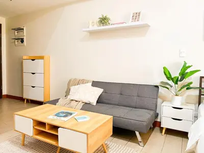 a living room with a couch and a coffee table at Luxury BGC Condo, Venice Grand Canal #vlrtc5h in Manila