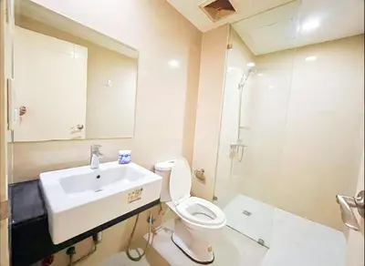 a bathroom with a sink and a toilet and a mirror at Luxury BGC Condo, Venice Grand Canal #vlrtc5h in Manila