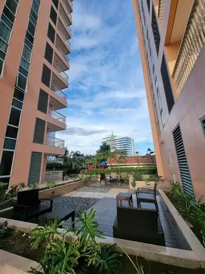 two benches in a courtyard between two buildings at Elegant Condo Beside Venice Grand Canal #vlra23j in Manila