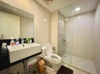 a bathroom with a sink and a toilet and a shower at Elegant Condo Beside Venice Grand Canal #vlra23j in Manila
