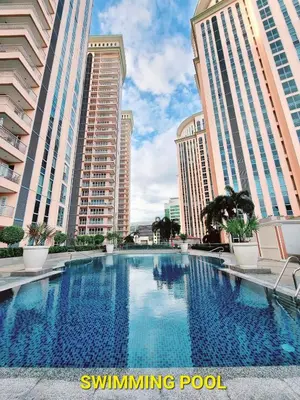 a swimming pool in a city with tall buildings at Elegant Condo Beside Venice Grand Canal #vlra23j in Manila