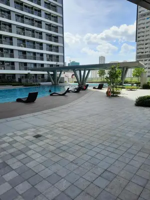 a bridge over a pool in a city with buildings at SMDC Fame Marcelle's Place near Mega Mall in Manila