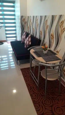 a living room with a table and a couch at SMDC Fame Marcelle's Place near Mega Mall in Manila
