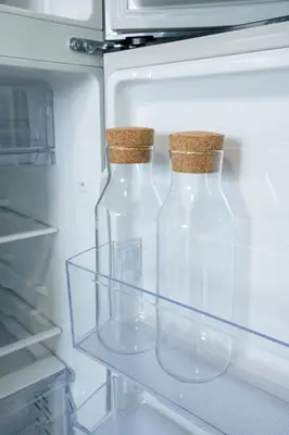 two clear glass bottles in an open refrigerator at Concrete Palms near MOA w/ awesome view of Manila in Manila