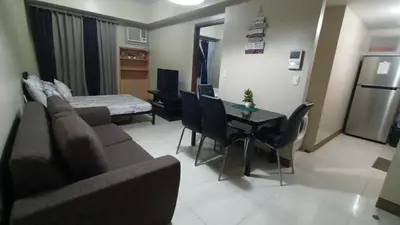 a living room with a couch and a table at 1 bedroom Condotel near Terminal3 Airport in Manila