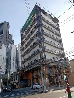 a tall building with cars parked on the side of it at St. Marvin Studio M603 in Manila