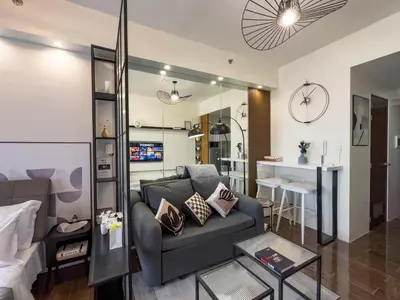 a living room with a couch and a table at GemstoneBR in SMDC Air Residences in Manila