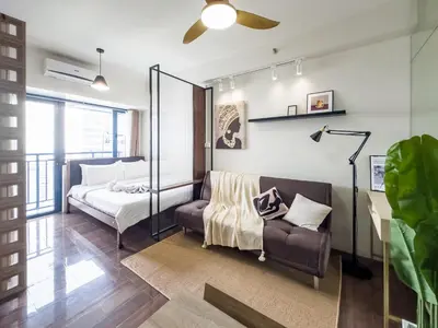 a bedroom with a bed and a couch at GemstoneBR in SMDC Air Residences in Manila