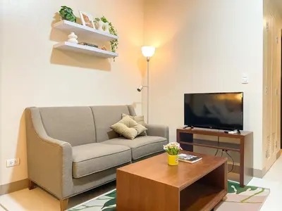 a living room with a couch and a tv at Chillhive Condo In Bgc Near Uptown Mall #ournw17a in Manila