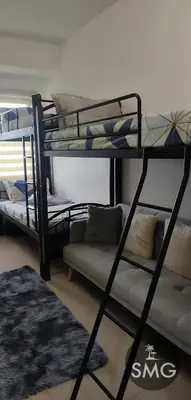 a living room with two bunk beds and a couch at SMG - Studio@Green2: Wi-fi, Netflix, Swim & Relax in Cavite
