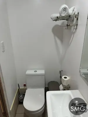 a small bathroom with a white toilet and a sink at SMG - Studio@Green2: Wi-fi, Netflix, Swim & Relax in Cavite