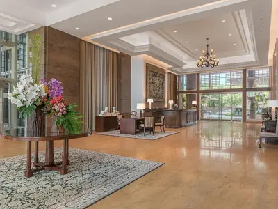 a lobby with a vase of flowers on a table at Discovery Primea in Manila