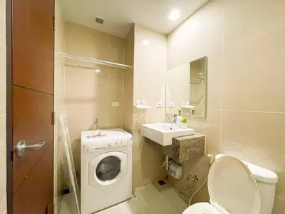 a bathroom with a washing machine and a sink at Cozy Bgc Stay Near Uptown Mall & Hyatt #ournw24l in Manila