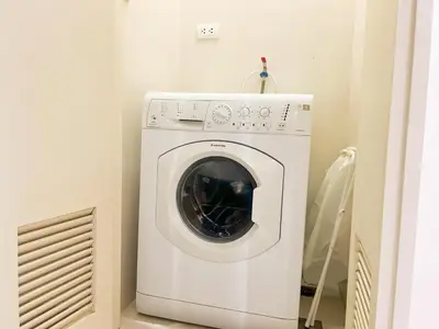 a white washer and dryer in a room at Bgc Condo Near Uptown Mall, Grand Hyatt #ournw25b in Manila