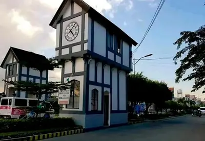 a blue and white building with a clock tower at Romantic 2BR Condo unit with free WiFi in Anabu Primero
