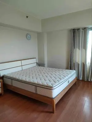 a bedroom with a large bed in a room at Staycation near SLMEC, US Embassy and Supreme Court in Manila