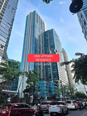 a street sign in front of some tall buildings at Cozy Stay In Bgc Near Uptown Mall #oursw11d1 in Manila