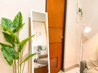 a bathroom with a mirror and a plant in a room at Top BGC Condo Across Grand Hyatt Hotel #oursw12k in Manila