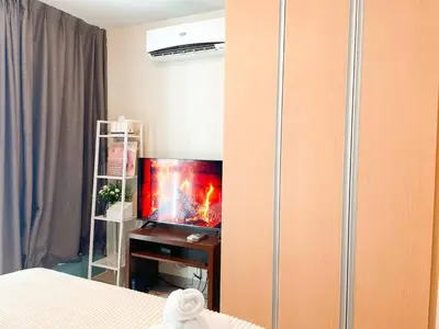 a bedroom with a tv in a room with a bed at Top BGC Condo Across Grand Hyatt Hotel #oursw12k in Manila