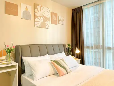 a bedroom with a bed and a window at Top BGC Condo Across Grand Hyatt Hotel #oursw12k in Manila