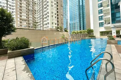 a large blue swimming pool with tall buildings at Bgc Staycation Across Uptown Mall #oursw29f in Manila