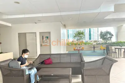 a woman sitting on a couch in a building at Bgc Condo At Uptown Mall, Grand Hyatt #oursw34b2 in Manila