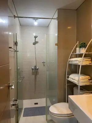 a bathroom with a shower with a toilet and a sink at Runway Walk Studio - Near NAIA Terminal3 in Manila