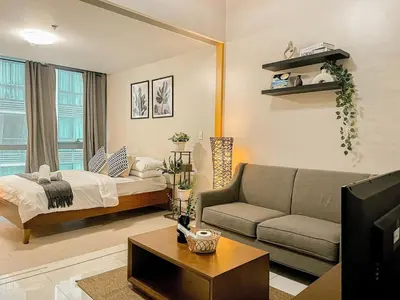 a living room with a bed and a couch at Prime Bgc Stay Near Uptown, Grand Hyatt #oursw18j in Manila