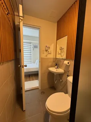 a bathroom with a toilet and a sink at K&K The Modern Crib at Holland Park Condo Southwoods City in Biñan