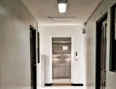 a hallway with a silver elevator in a building at Gorgeous 2BR Condo unit with free WiFi in Imus