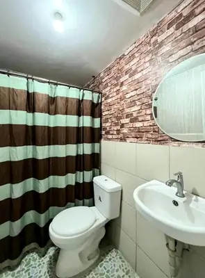 a bathroom with a toilet and a sink at Gorgeous 2BR Condo unit with free WiFi in Imus