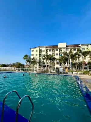 a large swimming pool with people in the water at The Barracks Staycation in Santa Rosa