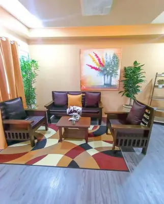 a living room with couches and a table at Urban Zen in Calamba
