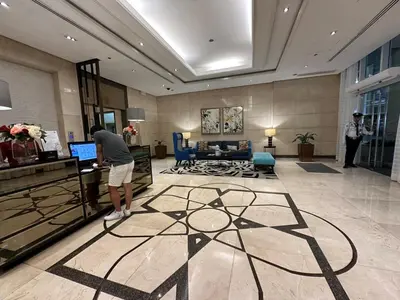 a man standing in a hotel lobby at Amazing Sunrise Venice Grand Canal Balcony, Xbox Series X console with Game Pass Ultimate, FREE coffee, Pool, Gym & Sauna, 5 mins to BGC in Manila