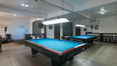 two pool tables are in a room with at RedDoorz @ Western Bicutan Transients Inn in Manila