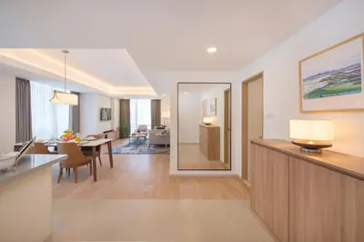 a living room with a kitchen and a dining room at Somerset Valero Makati in Manila