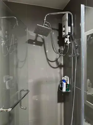 a shower with a shower head in a bathroom at My Hideaway@Air in Manila