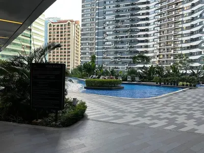 a swimming pool in a city with tall buildings at My Hideaway@Air in Manila